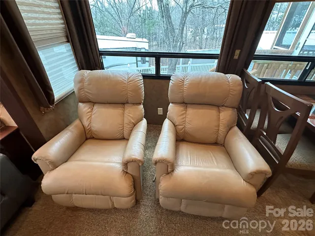 a balcony with furniture and a floor to ceiling window