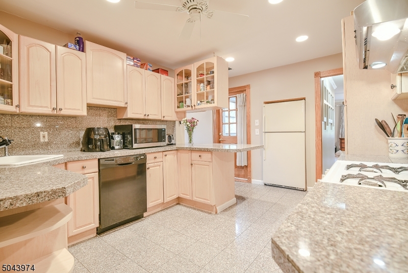 72 Rector Street Millburn, NJ 07041 - Photo 3 of 14 a kitchen with granite countertop a refrigerator and a stove top oven