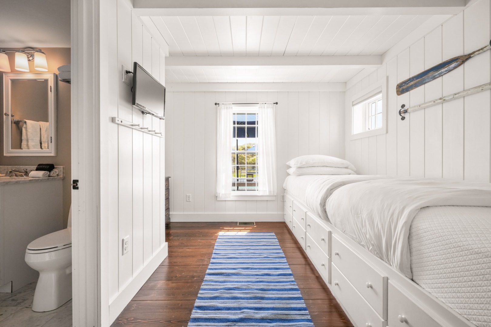 21 Quidnet Road Nantucket, MA 02554 - Photo 18 of 62 a spacious bedroom with a bed and a rug