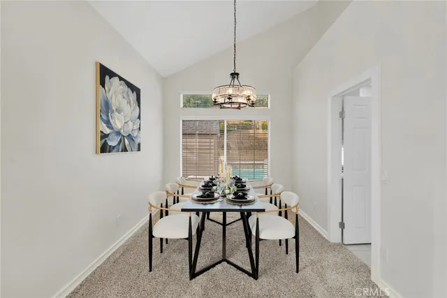 a view of a dining room with furniture and window