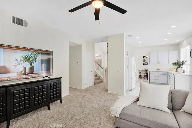 a living room with furniture a dining table and kitchen view