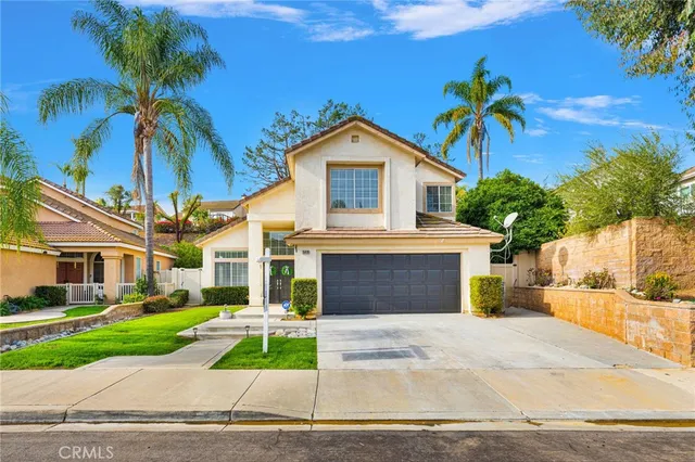 a front view of a house with a yard and a garage