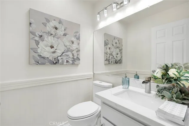 a bathroom with a toilet a sink and a mirror