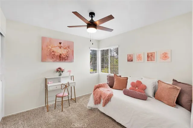 a bedroom with a bed and a desk