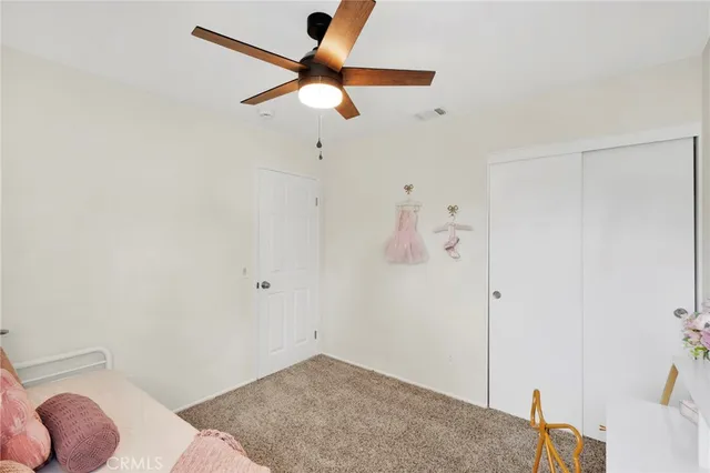 a view of a livingroom with a ceiling fan and wooden floor