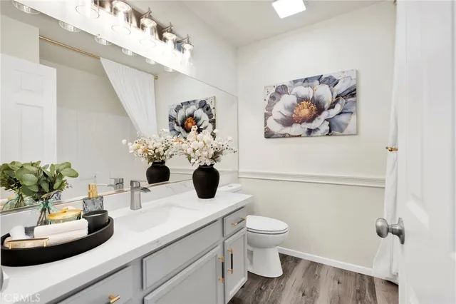 a bathroom with a sink a toilet and a mirror