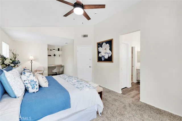 a bedroom with bed and the view of bathroom