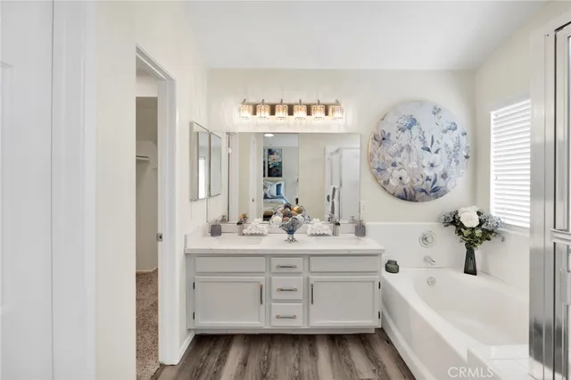 a bathroom with a bathtub sink and mirror