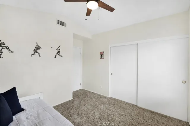 a bedroom with a bed and ceiling fan