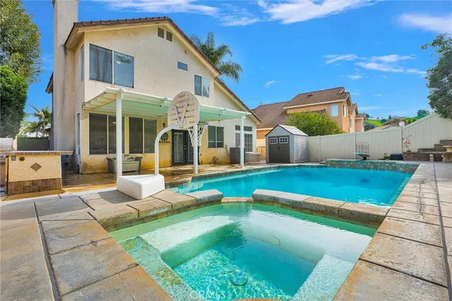 a view of house with swimming pool outdoor seating