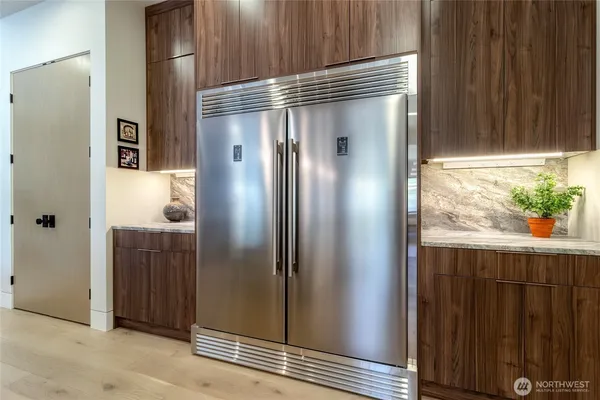 a kitchen with stainless steel appliances granite countertop a refrigerator and a sink