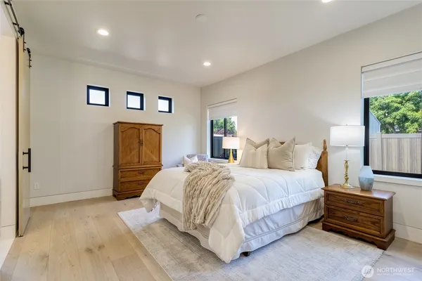 a bedroom with a bed and a couch