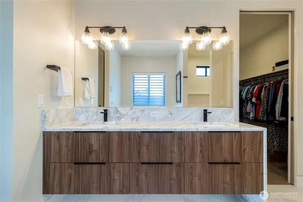 a bathroom with a sink double vanity and a mirror