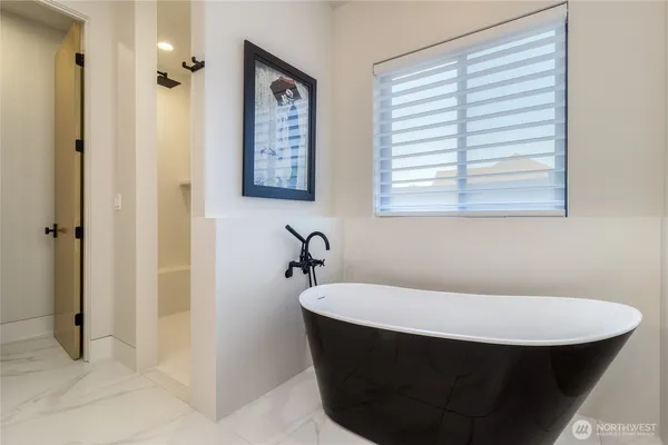 a bathroom with a bathtub and a sink