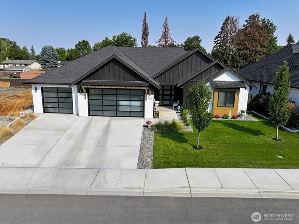 a house with a small yard and a large parking space