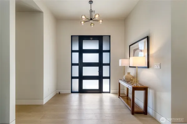 a view of a room with a window and wooden floor
