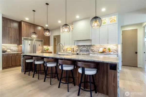 a kitchen with granite countertop a table chairs and a chandelier
