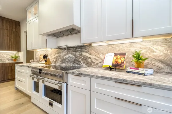 a kitchen with white cabinets and appliances