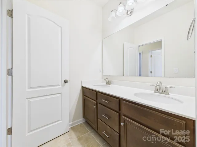 a bathroom with a double vanity sink and a mirror