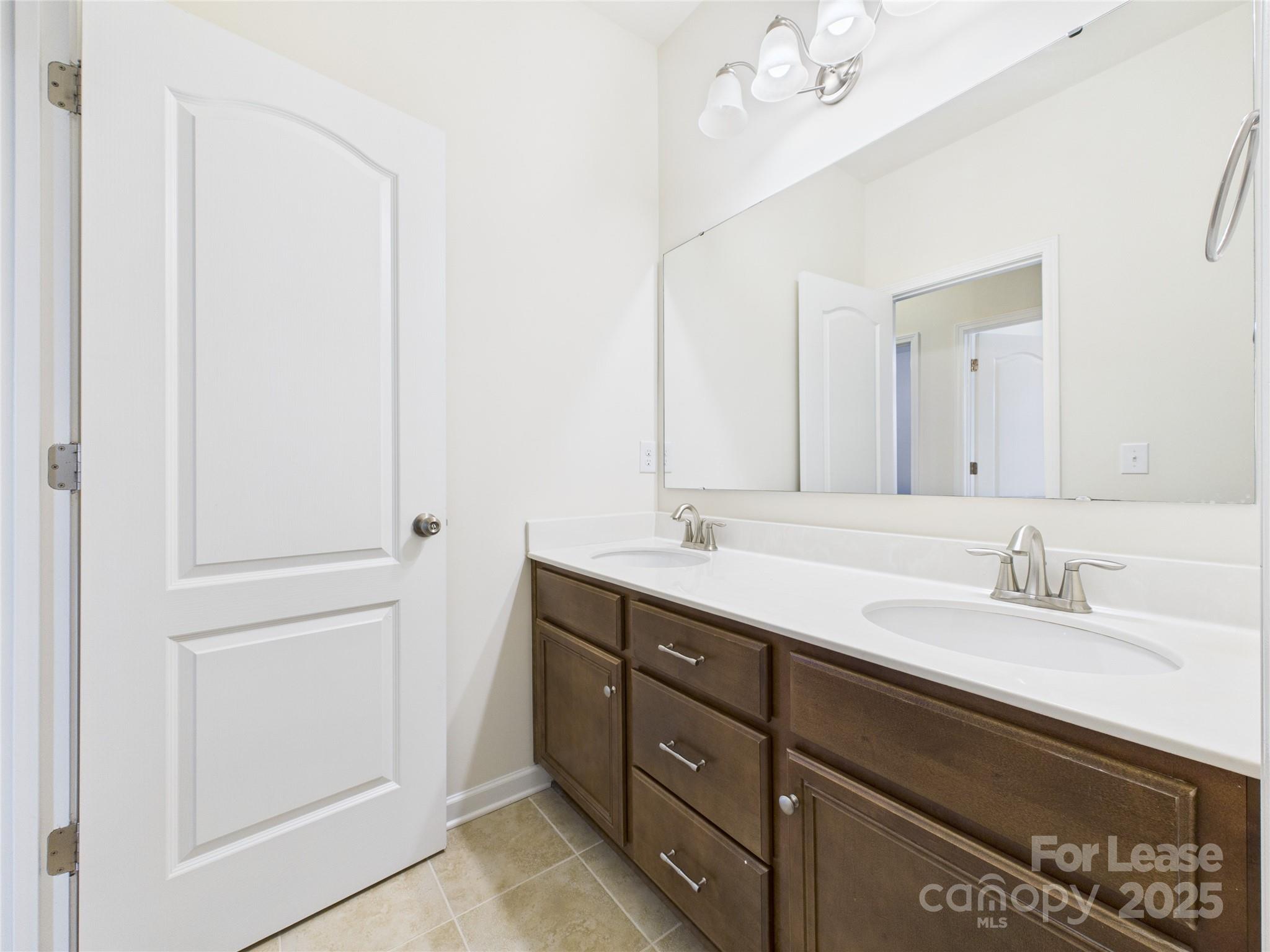 1249 Reflection Avenue Northwest Concord, NC 28027 - Photo 12 of 25 a bathroom with a double vanity sink and a mirror