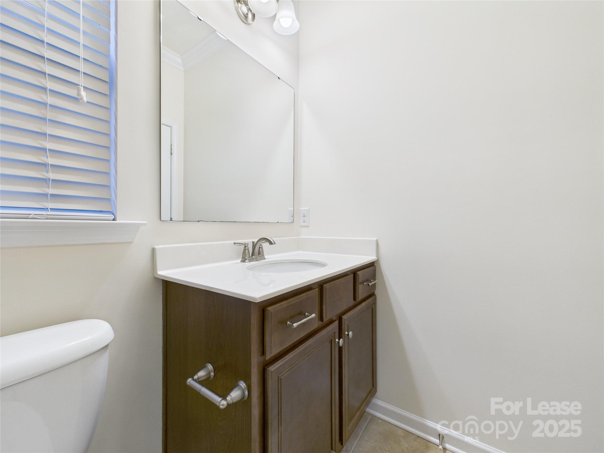 1249 Reflection Avenue Northwest Concord, NC 28027 - Photo 13 of 25 a bathroom with a sink and a toilet