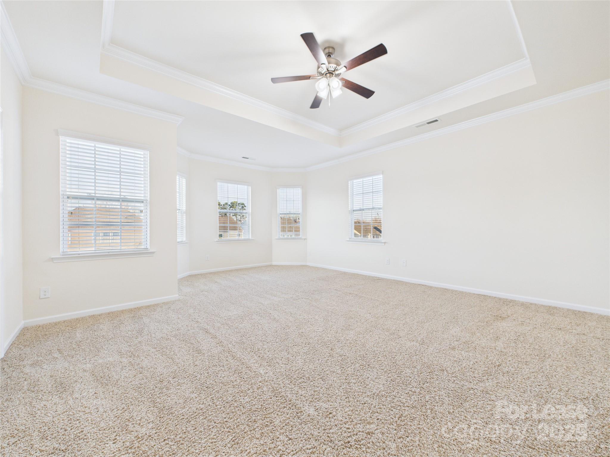 1249 Reflection Avenue Northwest Concord, NC 28027 - Photo 20 of 25 an empty room with windows and fan