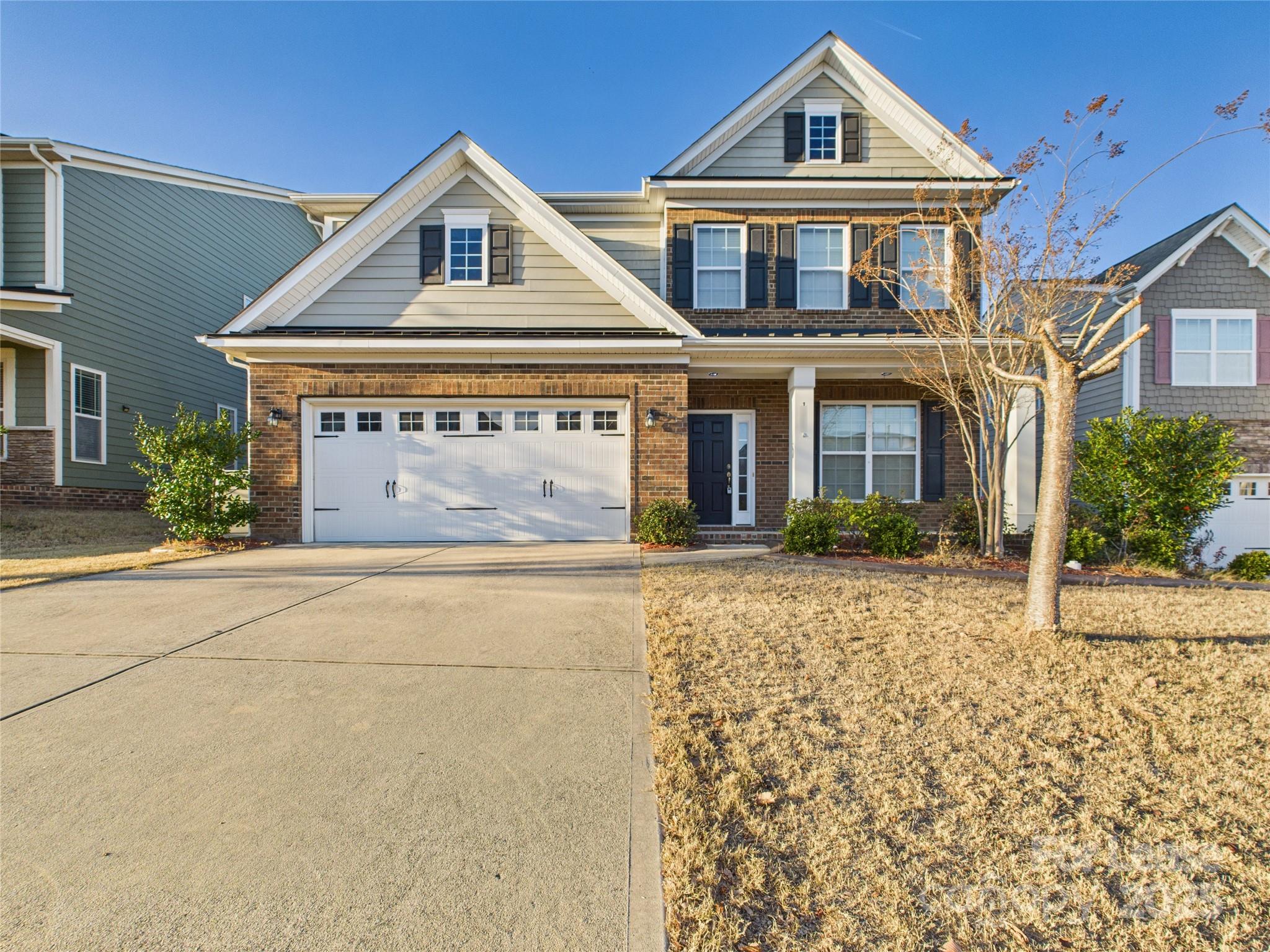 1249 Reflection Avenue Northwest Concord, NC 28027 - Photo 2 of 25 a front view of a house with a garden