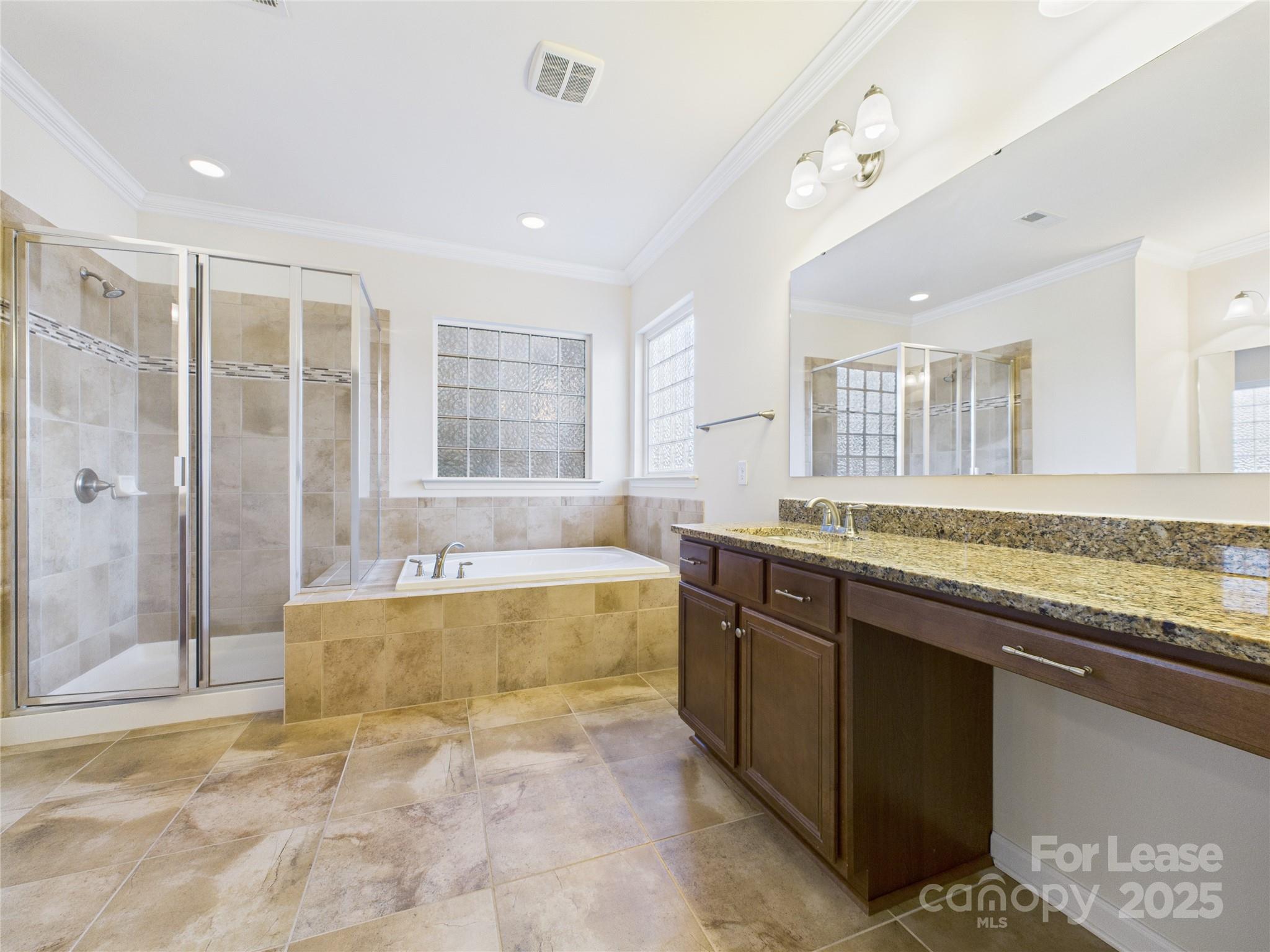 1249 Reflection Avenue Northwest Concord, NC 28027 - Photo 5 of 25 a large bathroom with a granite countertop tub sink and mirror