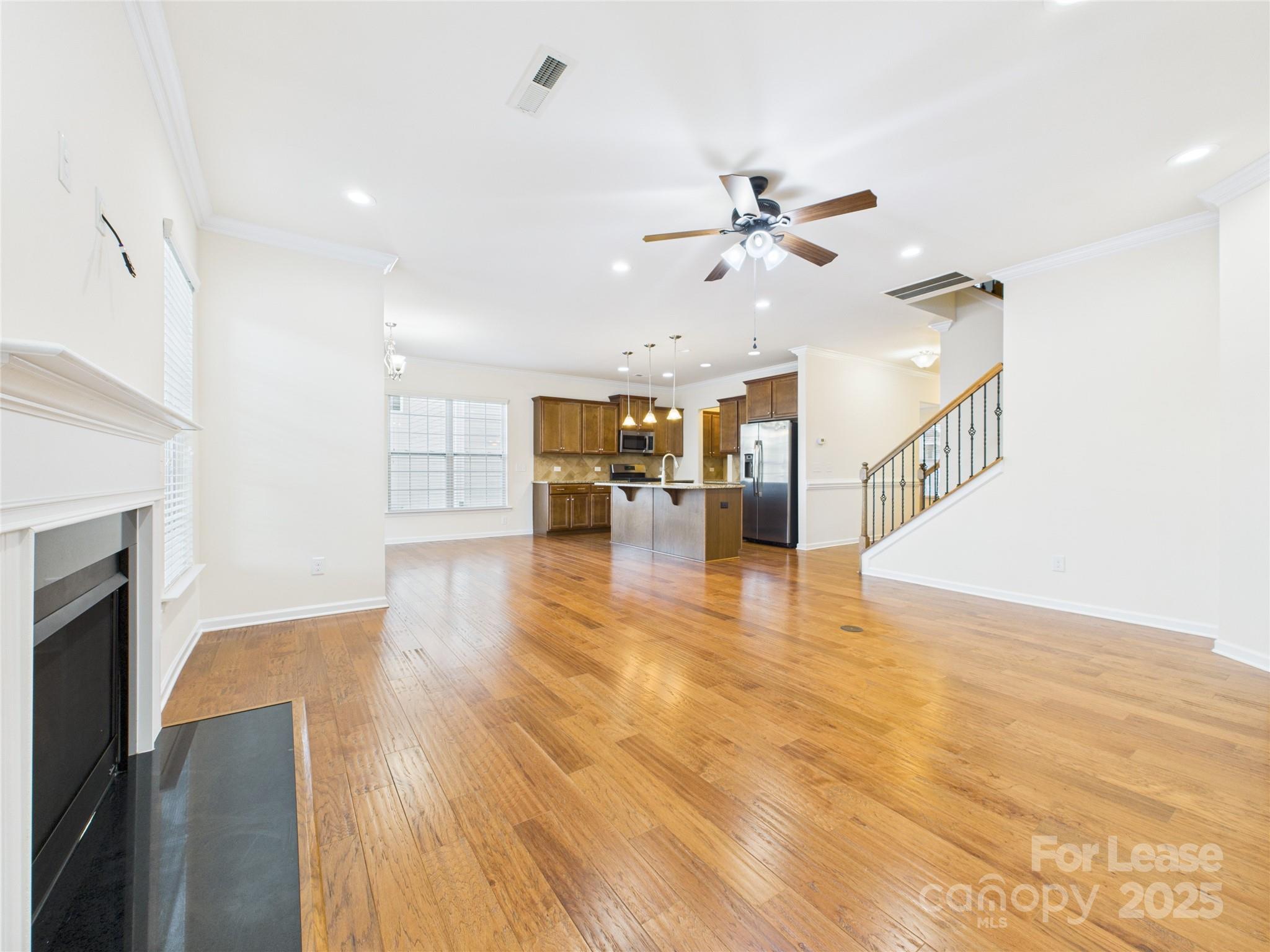 1249 Reflection Avenue Northwest Concord, NC 28027 - Photo 7 of 25 a view of empty room with wooden floor and fireplace