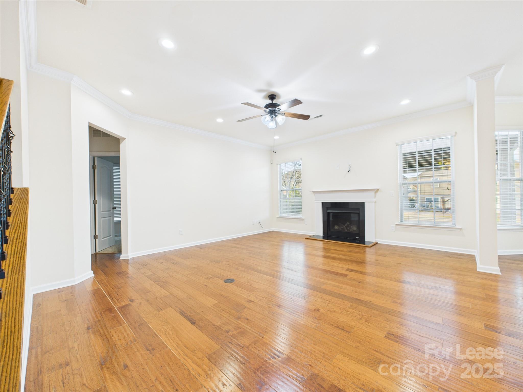1249 Reflection Avenue Northwest Concord, NC 28027 - Photo 8 of 25 a view of empty room with wooden floor and fireplace