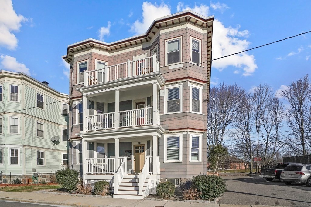 12 Clover Street, Unit 2 Boston, MA 02122 - Photo 11 of 13 a front view of a residential apartment building with a yard