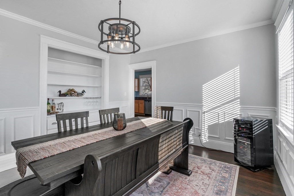 12 Clover Street, Unit 2 Boston, MA 02122 - Photo 2 of 13 a room with a chandelier furniture a rug and a window