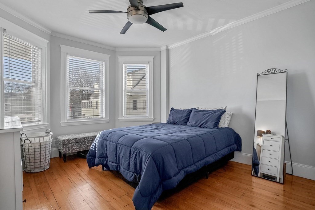 12 Clover Street, Unit 2 Boston, MA 02122 - Photo 7 of 13 a bedroom with a bed and wooden floor