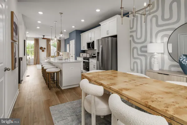a kitchen with stainless steel appliances kitchen island granite countertop a refrigerator and a stove top oven