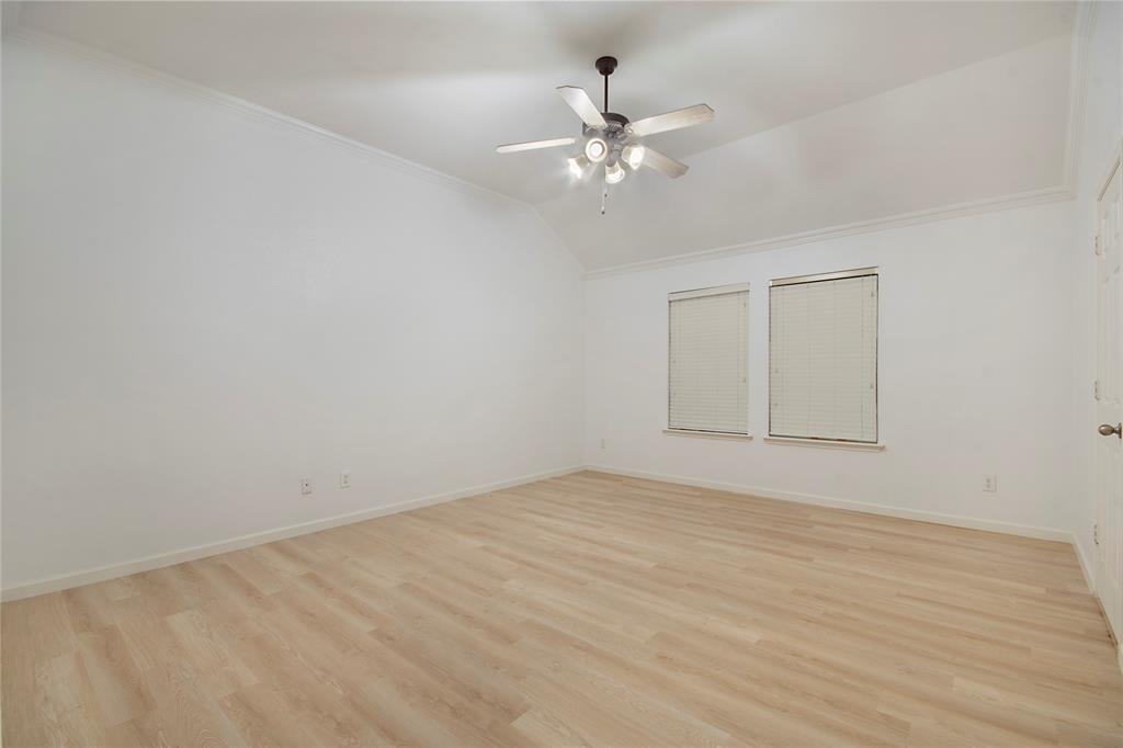 549 Hickory Lane Fate, TX 75087 - Photo 12 of 22 a view of an empty room with wooden floor and a chandelier fan