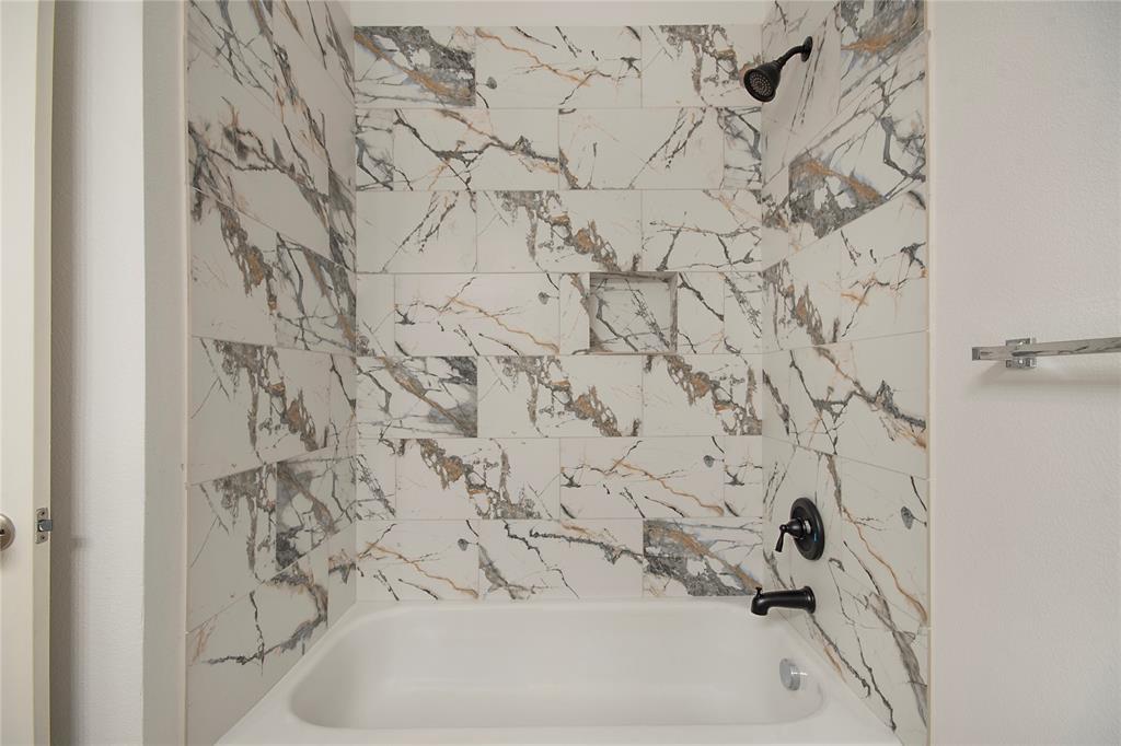 549 Hickory Lane Fate, TX 75087 - Photo 21 of 22 a bathroom with a bathtub and shower