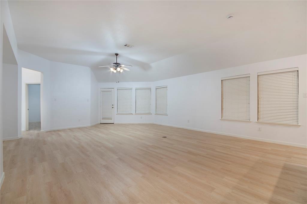 549 Hickory Lane Fate, TX 75087 - Photo 7 of 22 a view of an empty room with a ceiling fan