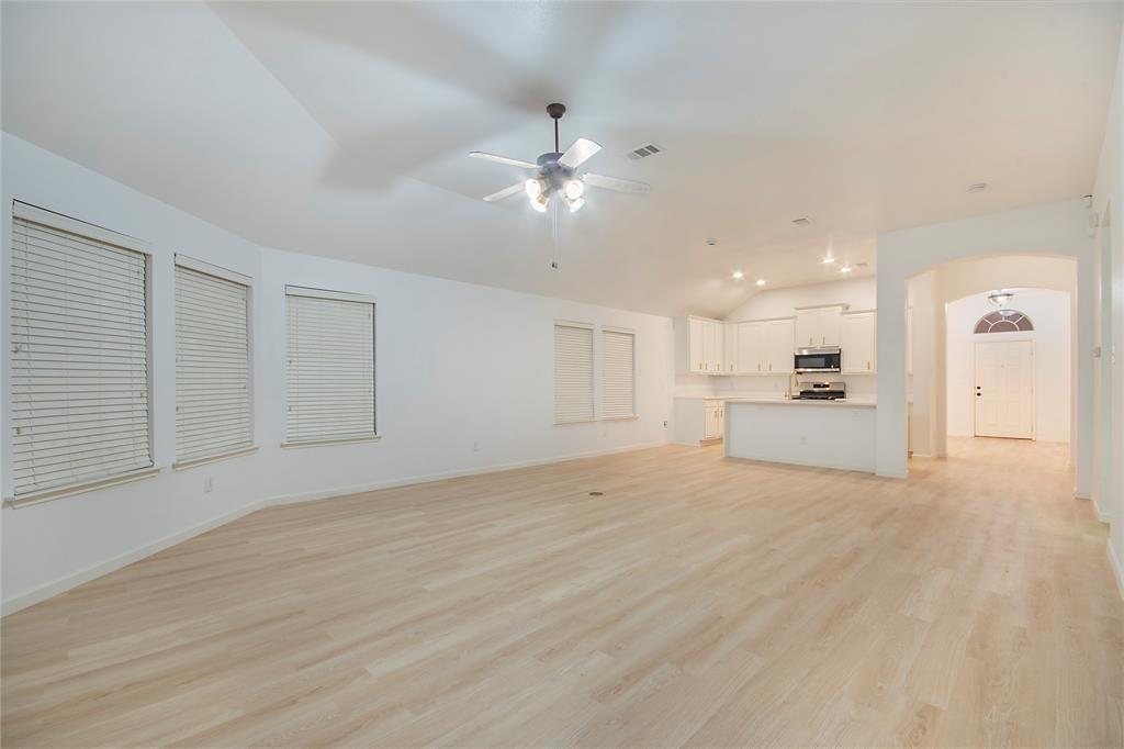 549 Hickory Lane Fate, TX 75087 - Photo 9 of 22 a view of a kitchen with a sink and a refrigerator