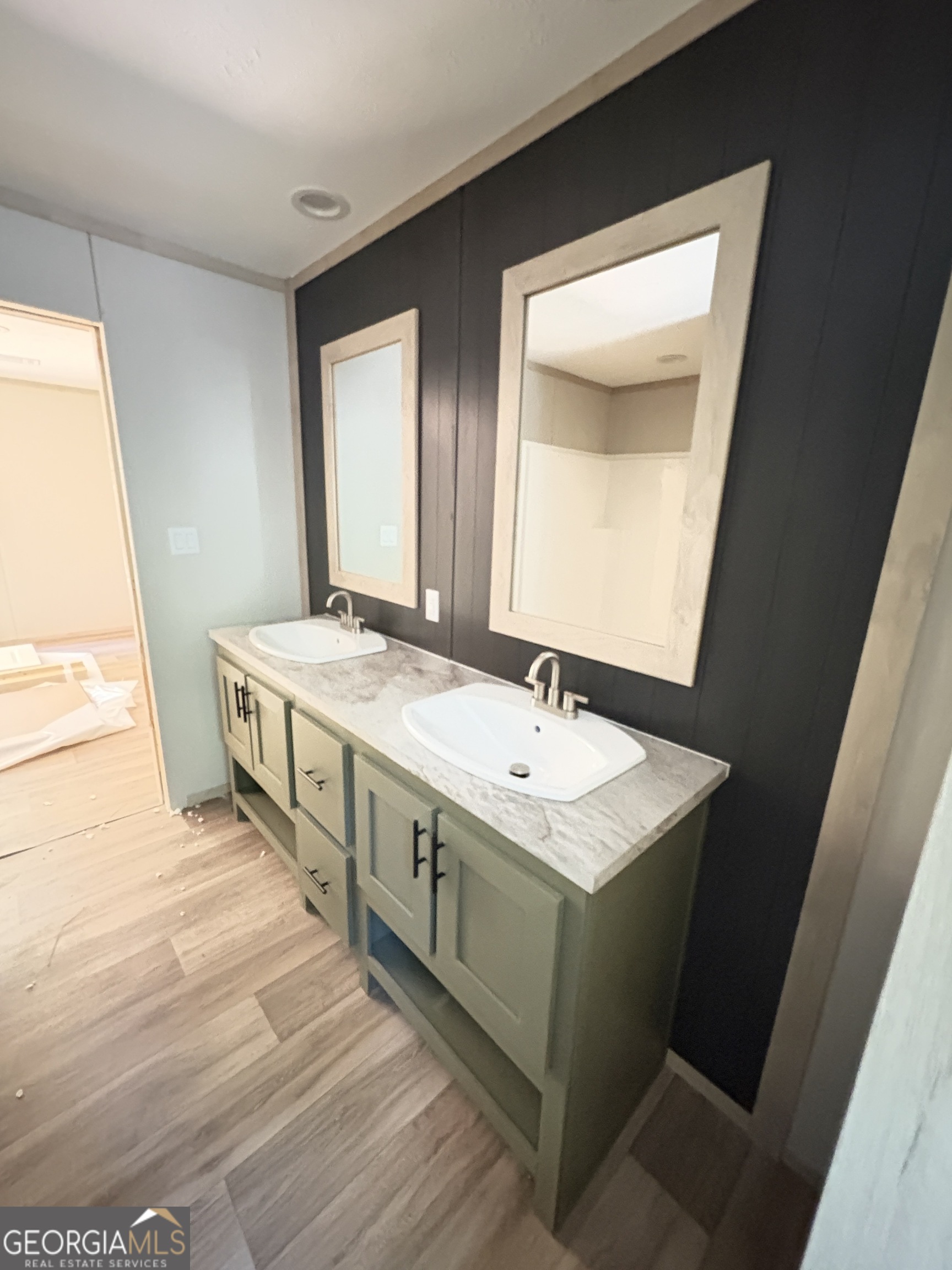 1020 Neal Road Commerce, GA 30530 - Photo 19 of 25 a bathroom with a double vanity sink and a mirror