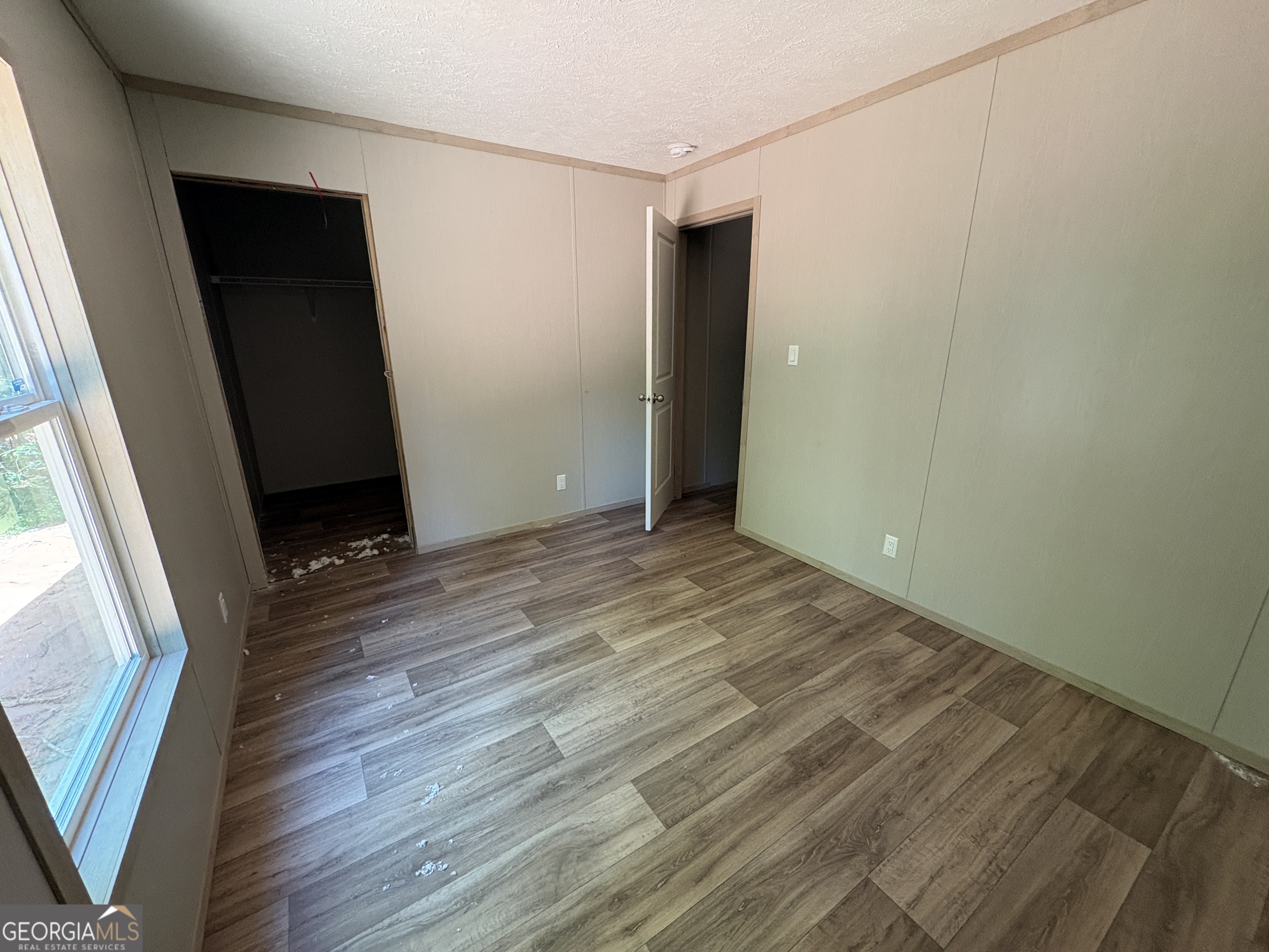 1020 Neal Road Commerce, GA 30530 - Photo 24 of 25 an empty room with wooden floor and window