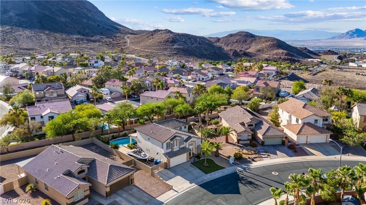 708 Vortex Avenue Henderson, NV 89002 - Photo 64 of 71 An aerial perspective reveals a residential community nestled against a rugged mountain landscape.