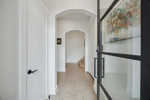 a kitchen with stainless steel appliances granite countertop a stove refrigerator and chairs