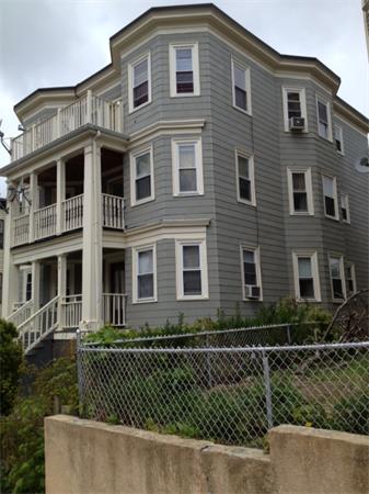 98 Montebello Road Boston, MA 02130 - Photo 2 of 4 a front view of a house with a garden