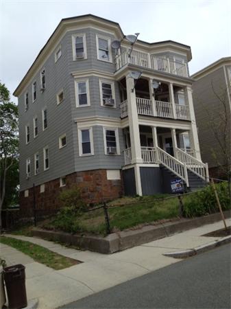 98 Montebello Road Boston, MA 02130 - Photo 3 of 4 a front view of a house with a yard