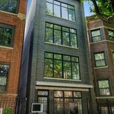 a view of a brick building next to a yard