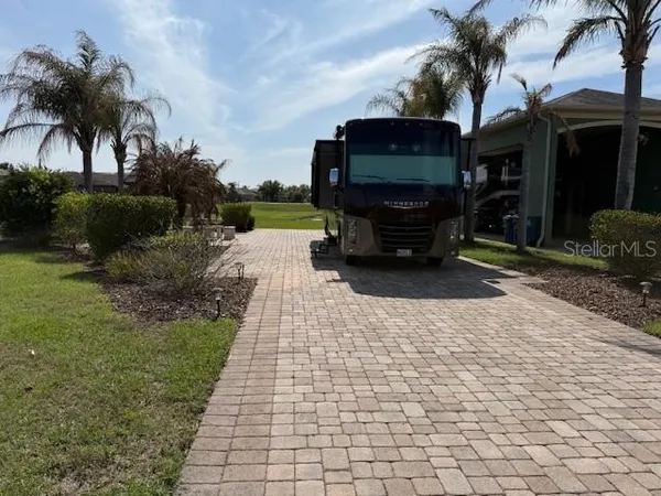 a car parked in front of a house and a yard