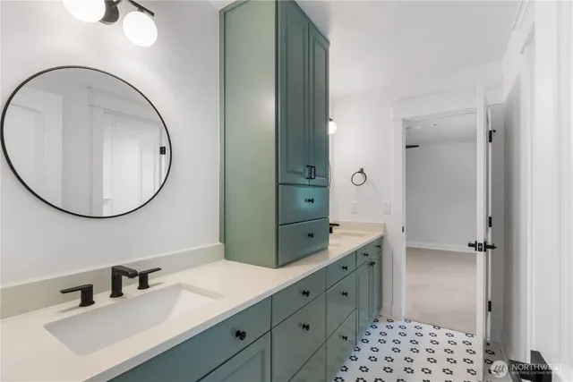 a bathroom with a sink a mirror and a shower