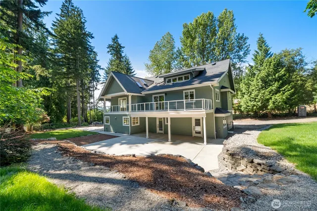 a view of a house with backyard porch and sitting area