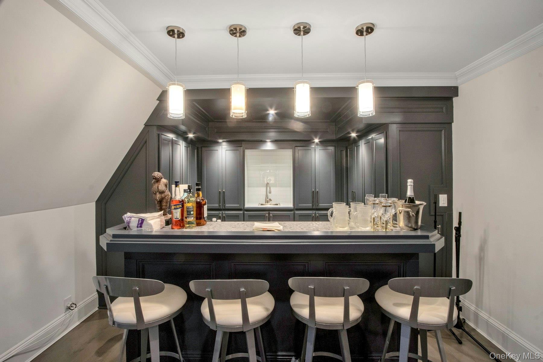 129 Washington Spring Road Palisades, NY 10964 - Photo 22 of 44 Den Bar with sink, hardwood / wood-style floors, pendant lighting, and ornamental molding