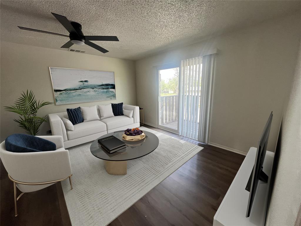 Living area featuring a textured ceiling, dark wood-style flooring, and a ceiling fan